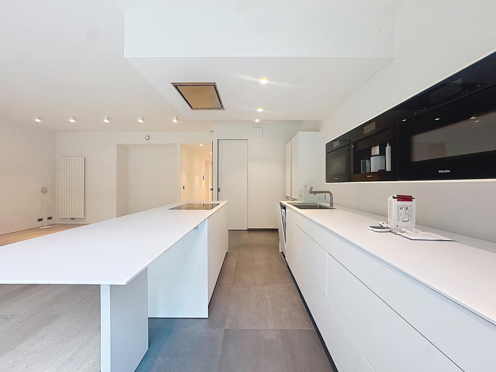 Cuisine Ouverte Avec Îlot Central – You Real Estate Agency Cuisine ouverte moderne avec îlot central blanc dans appartement contemporain.