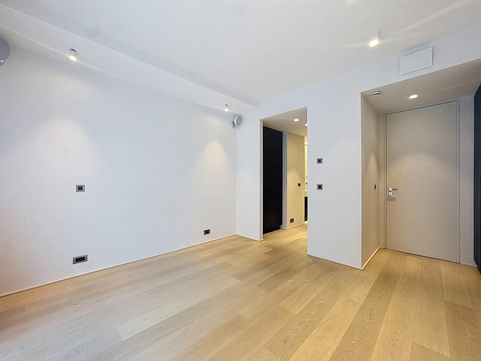 Salon Lumineux Avec Parquet – You Real Estate Agency Salon vide d’appartement moderne avec parquet bois et éclairage encastré.