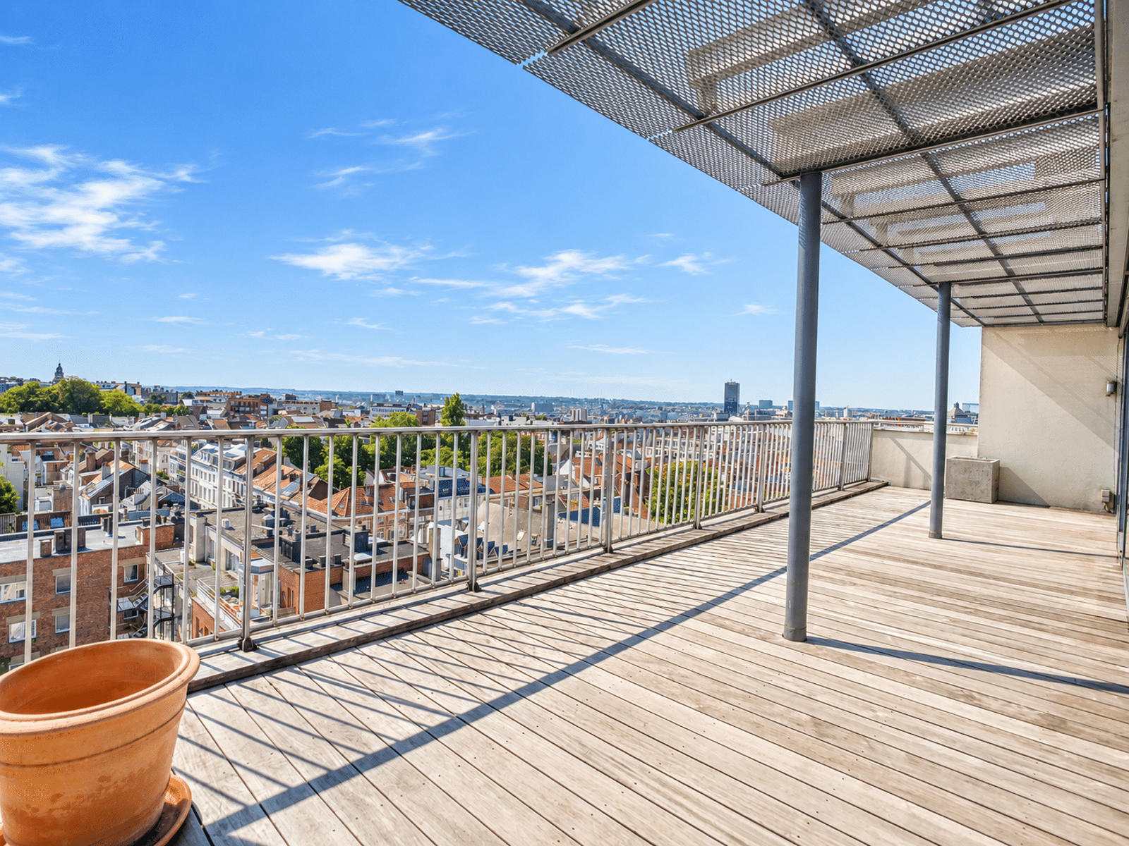 Panoramic Terrace with City Views – You Real Estate Agency Apartment terrace with a panoramic view of the city.