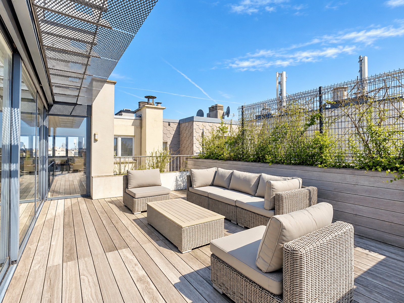 Rooftop Terrace with Outdoor Lounge – You Real Estate Agency Modern rooftop terrace with an outdoor lounge area and city views.