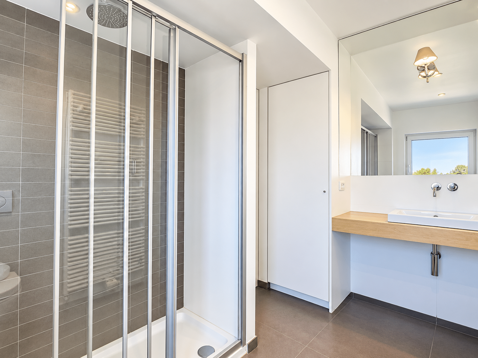 Bathroom with Italian shower - You Real Estate Agency Modern bathroom with a walk-in shower and a wooden vanity.