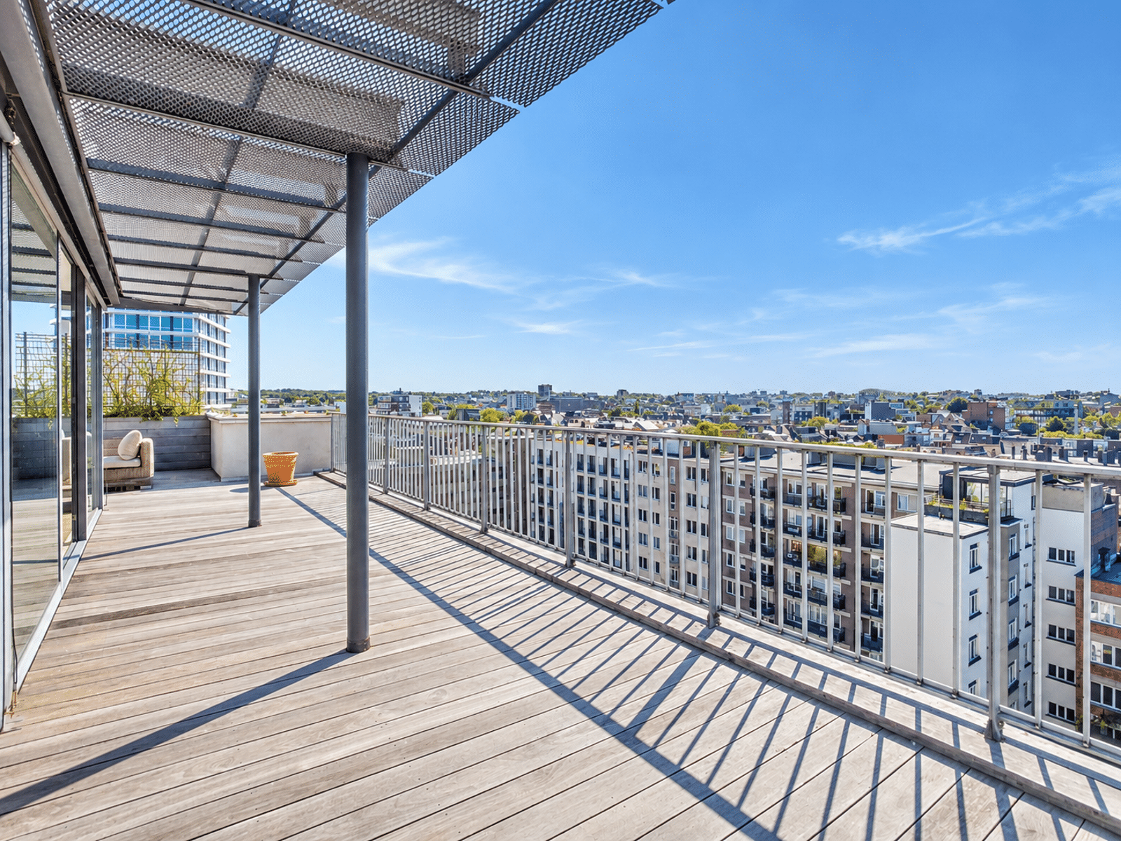 Large Terrace with City Views – You Real Estate Agency Large apartment terrace with a panoramic view of the city.