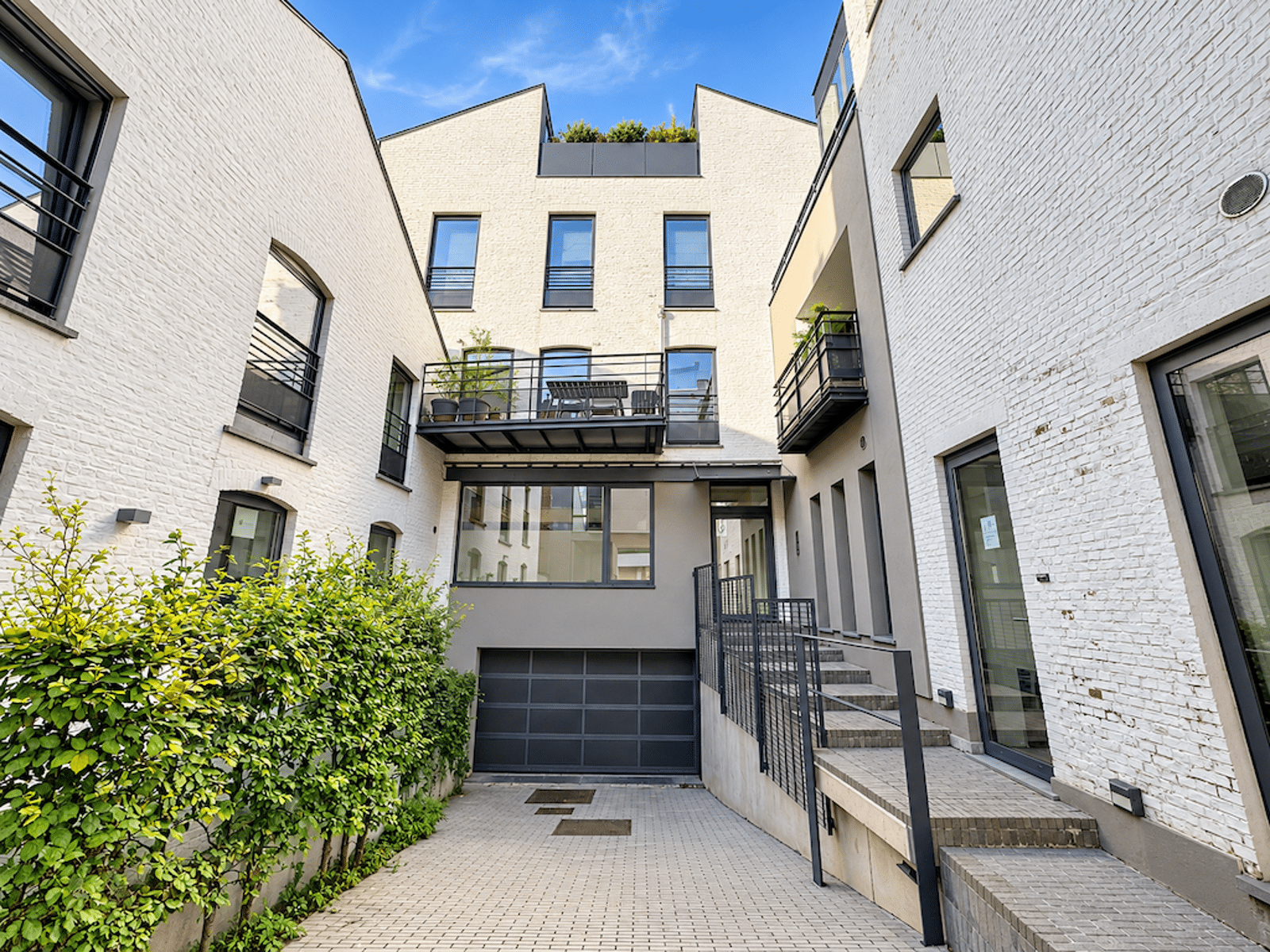 Cour Intérieure Moderne Avec Garage – You Real Estate Agency Cour intérieure moderne d’appartements avec terrasse, balcons et garage privé.